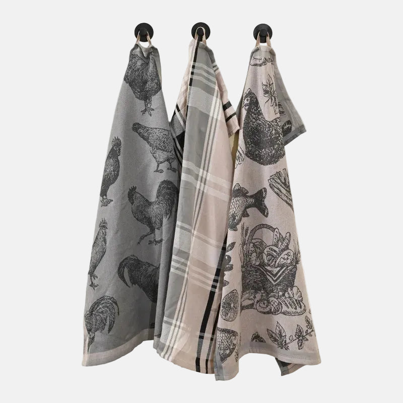 Set of three kitchen towels with rooster patterns hanging on a rack.