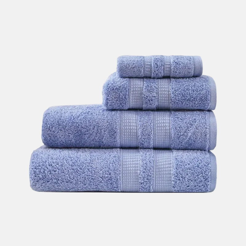 Set of four blue towels stacked on a white background